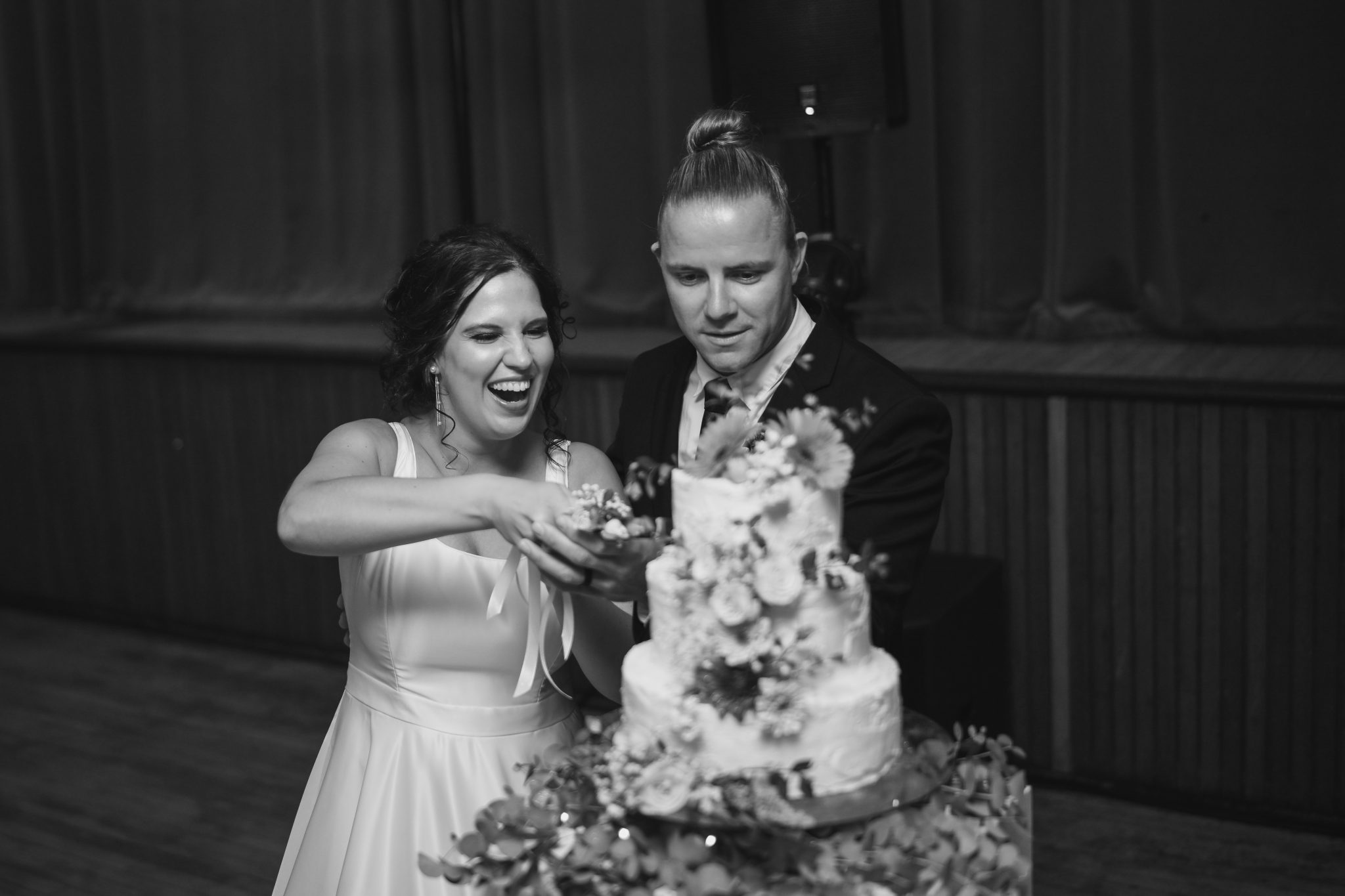 Couple holding Pretzel's graduation certificate in kitchen